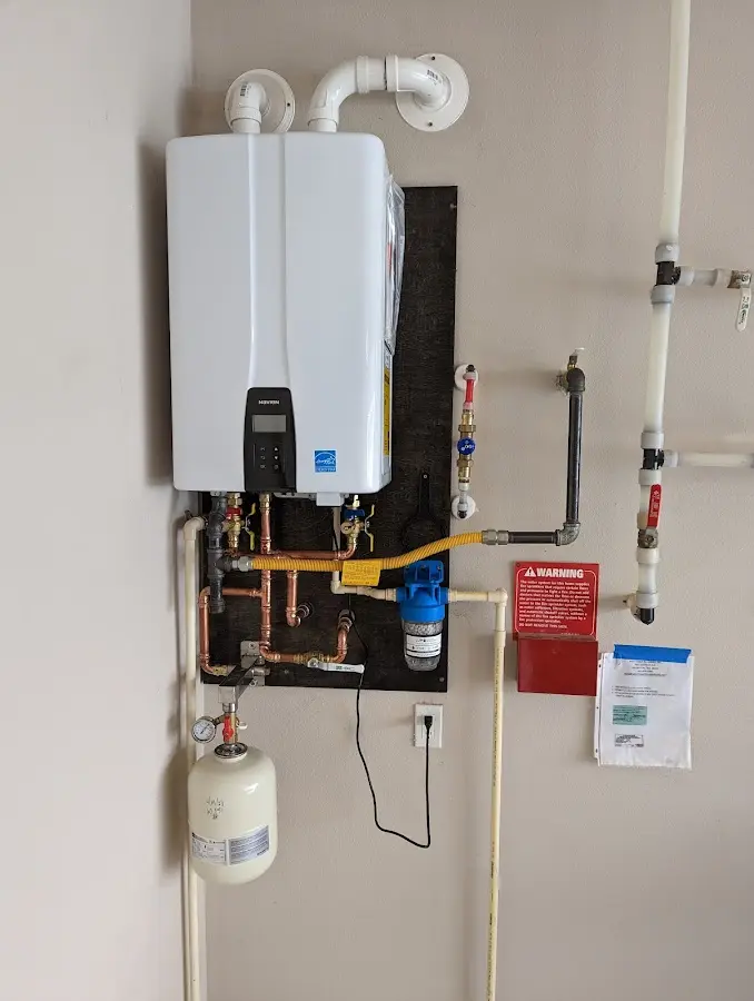 Professional plumber installing copper piping in a Crete home